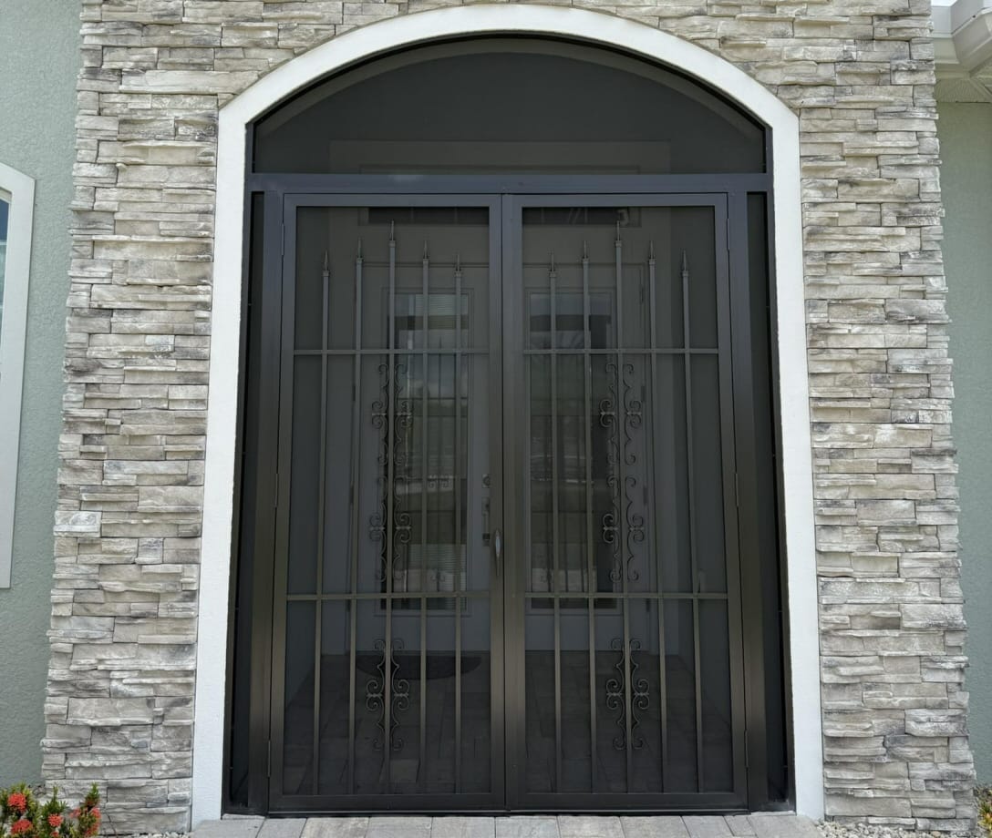 Florida home with aluminum lanai enclosure surrounded by palm trees